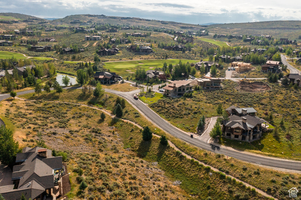 Aerial view of property's location with a mountainous background and nearby suburban area
