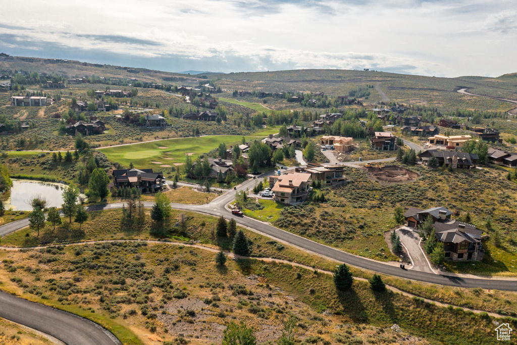 Aerial view of property and surrounding area with a mountainous background