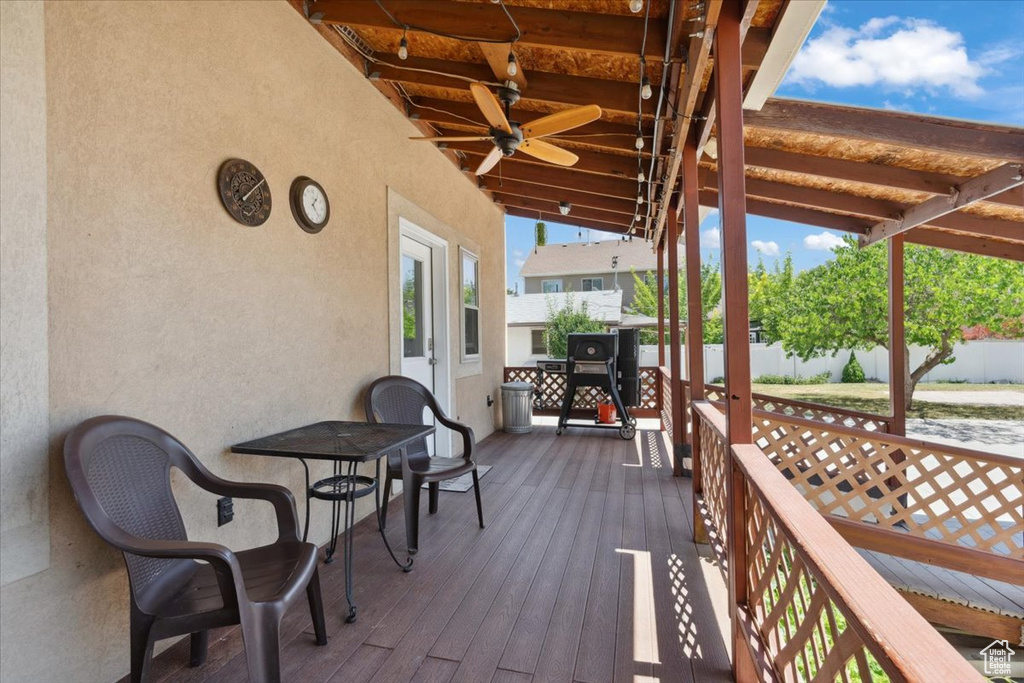 Wooden deck featuring ceiling fan