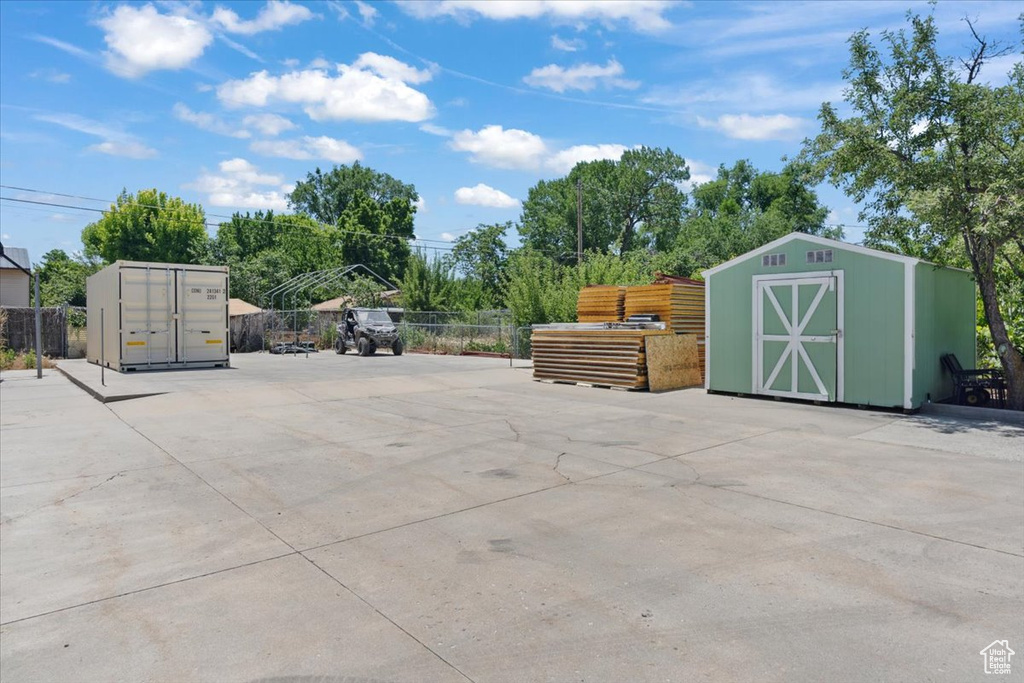 View of patio featuring a shed