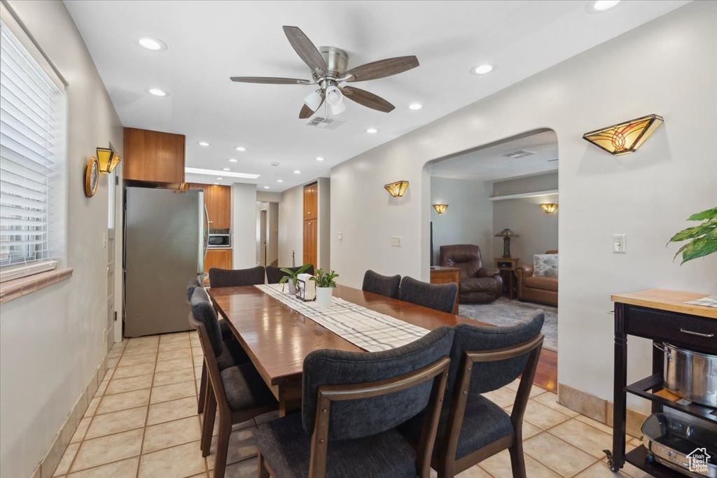 Dining space with a ceiling fan, light tile patterned flooring, and recessed lighting