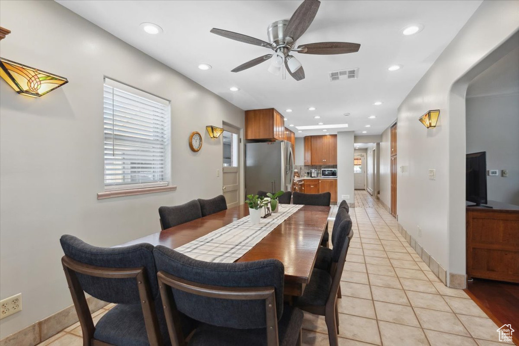 Dining space featuring a ceiling fan, light tile patterned flooring, and recessed lighting