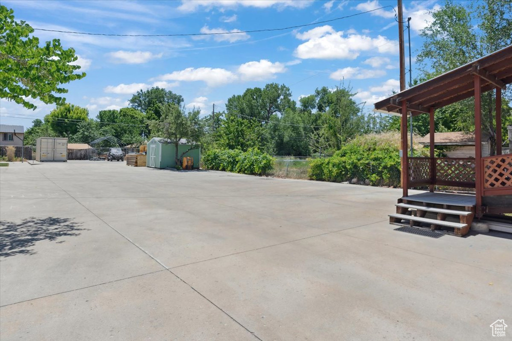 View of patio / terrace with a storage shed and a wooden deck