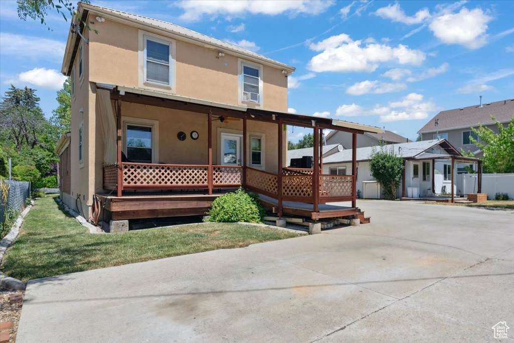 View of front of property with stucco siding and a deck