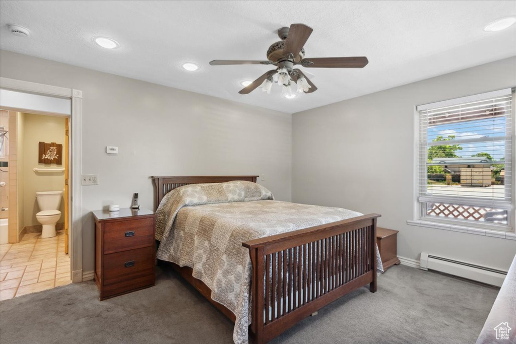 Bedroom featuring a baseboard radiator, light colored carpet, ceiling fan, recessed lighting, and ensuite bath