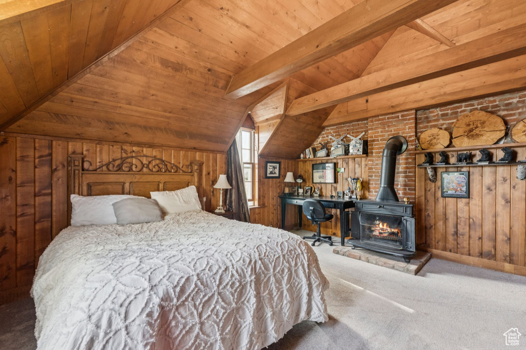 Bedroom featuring carpet floors, wood ceiling, wood walls, and a wood stove