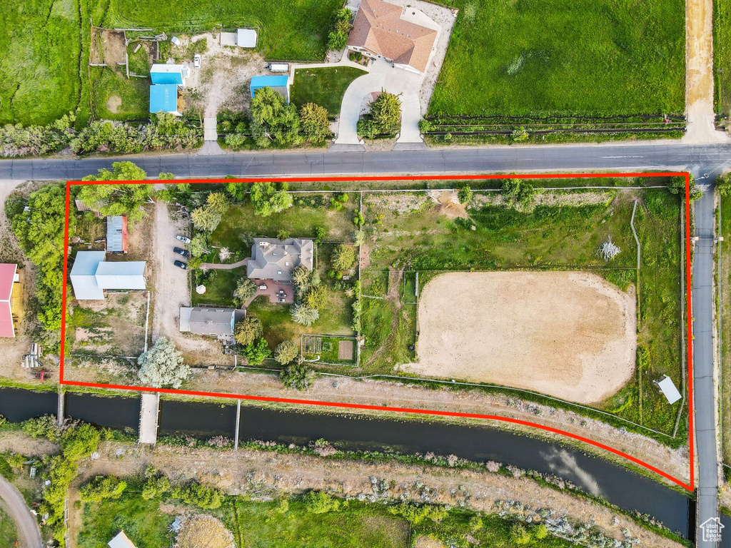 Aerial view of property and surrounding area featuring property parcel outlined