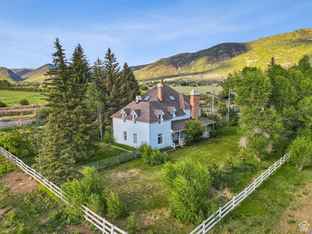 View of subject property featuring a mountainous background