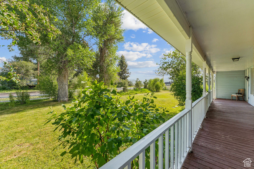 Porch featuring a lawn