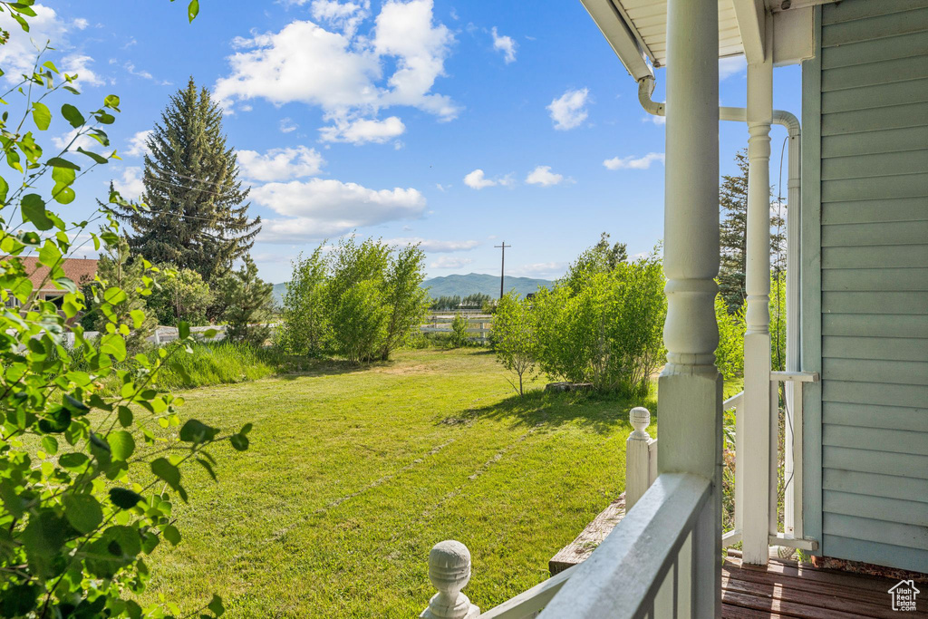 View of green lawn featuring a mountain view
