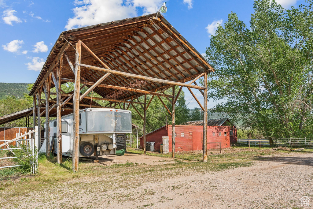 View of parking with a carport and dirt driveway