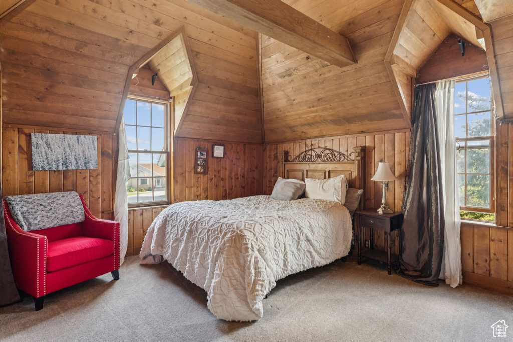 Bedroom with wood walls, carpet floors, and wood ceiling