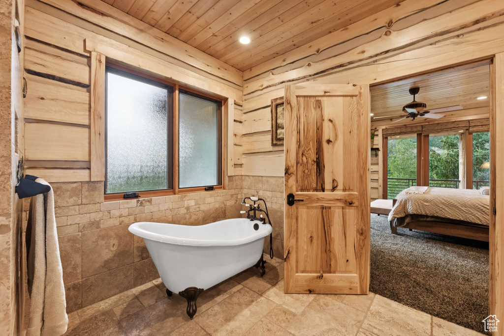 Bathroom with wooden ceiling, a soaking tub, ceiling fan, ensuite bathroom, and recessed lighting