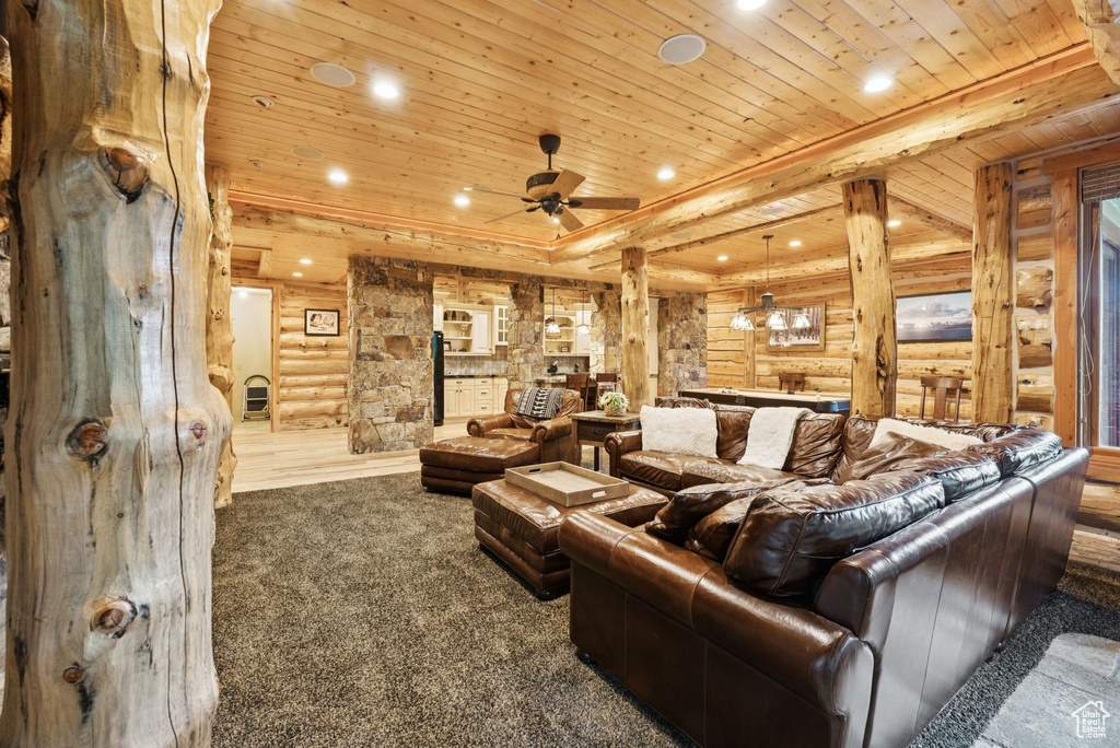 Cinema featuring rustic walls, wood ceiling, recessed lighting, carpet, and ceiling fan