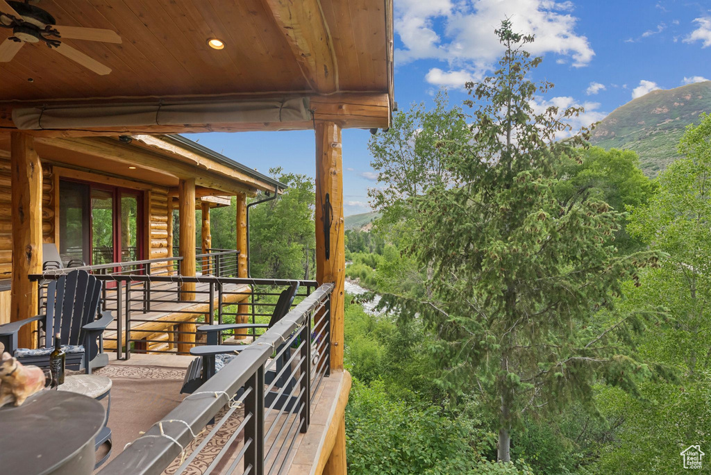 Balcony with a mountain view and a ceiling fan