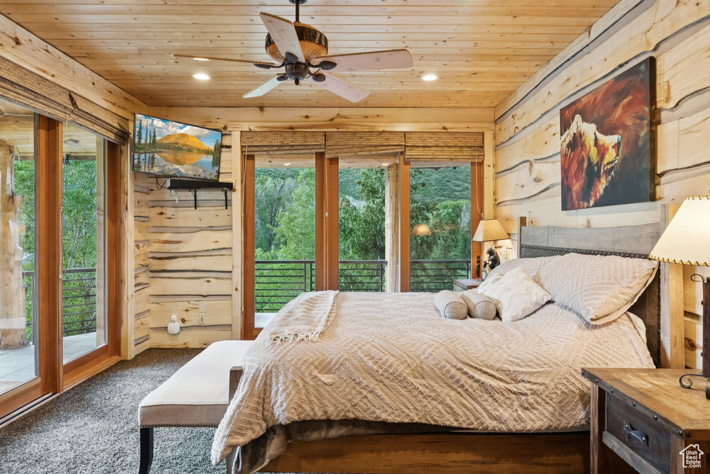 Bedroom with wooden ceiling, access to outside, recessed lighting, wooden walls, and carpet floors