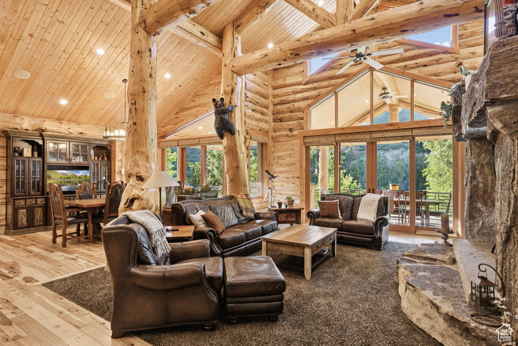 Living area featuring high vaulted ceiling, french doors, a wooden ceiling with exposed beams, recessed lighting, and ceiling fan