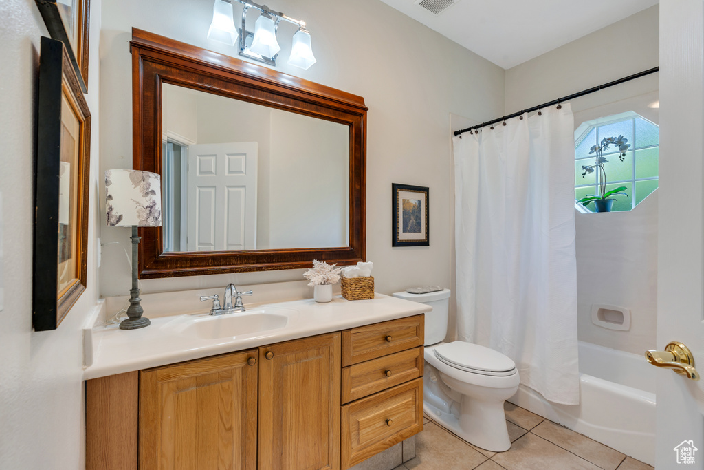 Full bath featuring vanity, tile patterned flooring, and shower / bath combination with curtain