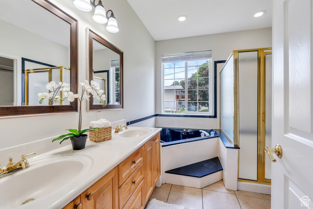 Bathroom featuring a shower stall, tile patterned flooring, double vanity, a garden tub, and recessed lighting