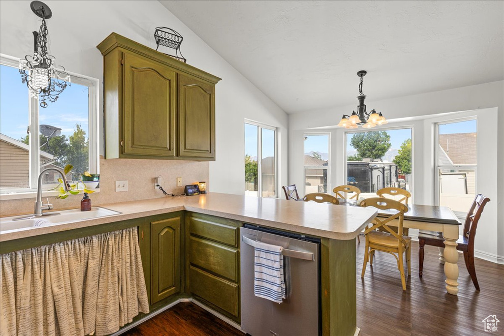 Kitchen featuring a chandelier, lofted ceiling, light countertops, dark wood-type flooring, and a peninsula