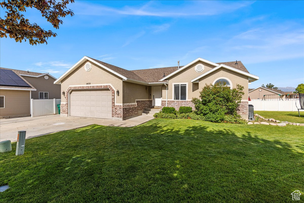 Single story home featuring stucco siding, a garage, concrete driveway, brick siding, and roof with shingles