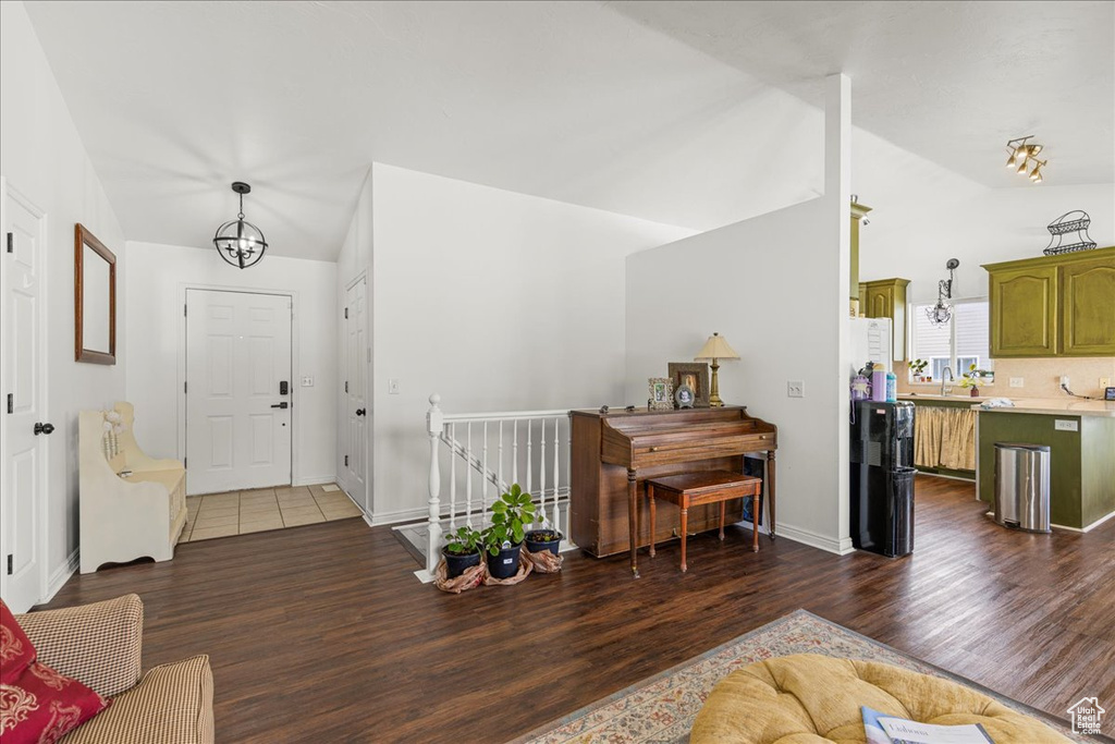 Living area with lofted ceiling and wood finished floors