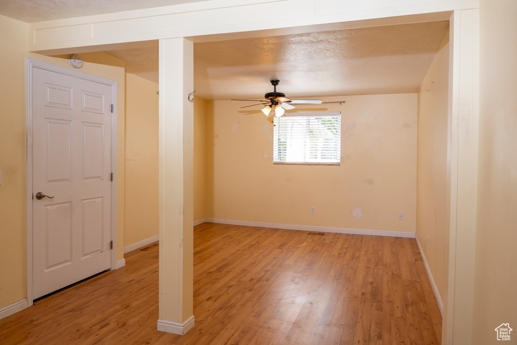 Spare room featuring light wood-style flooring and a ceiling fan