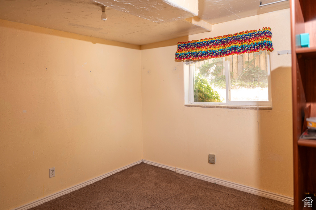 Carpeted spare room with baseboards