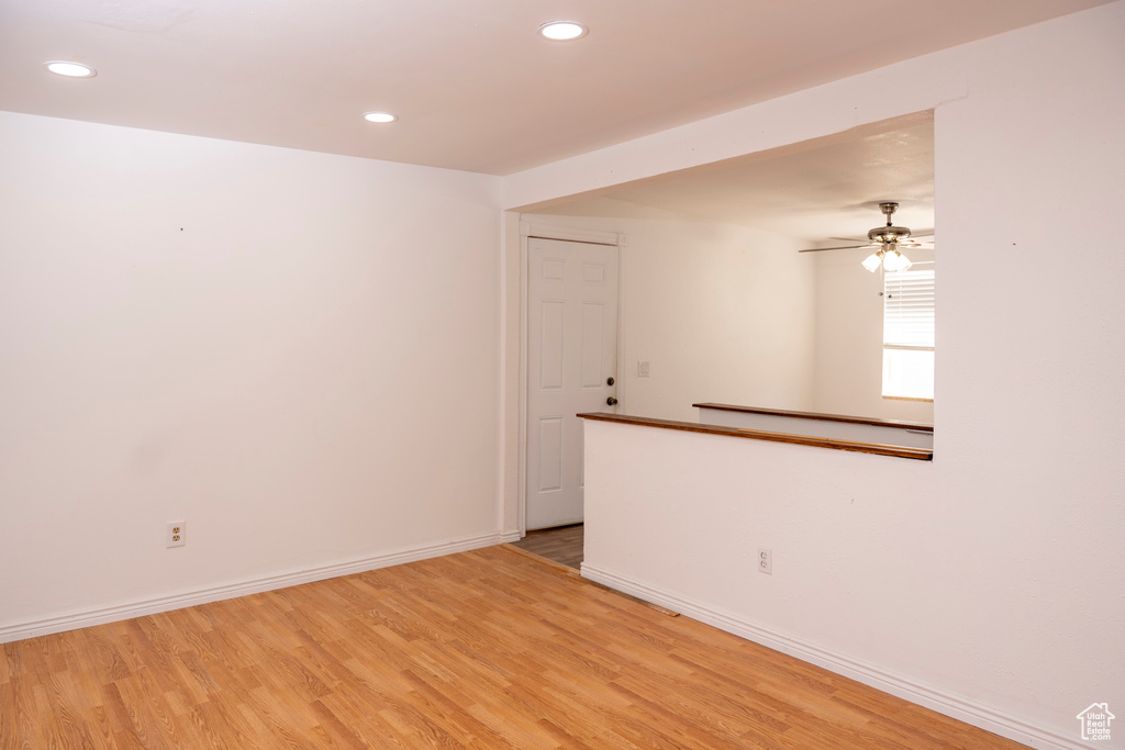 Empty room featuring light wood-style floors, recessed lighting, and ceiling fan