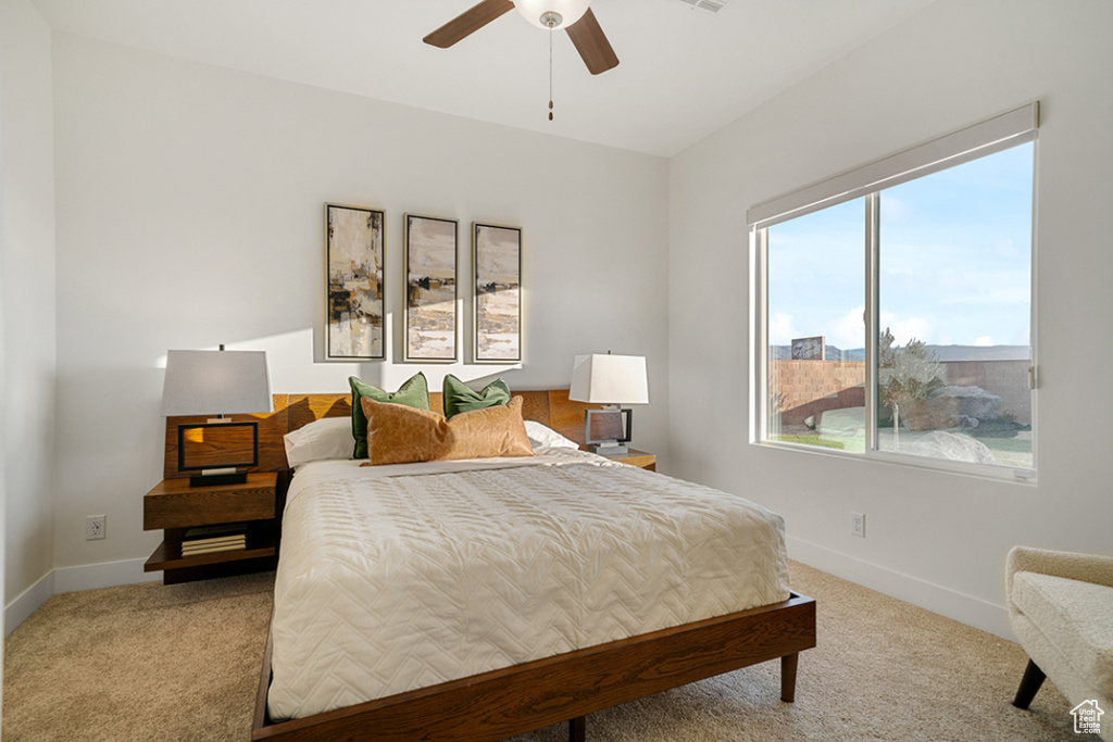 Bedroom featuring light colored carpet and ceiling fan