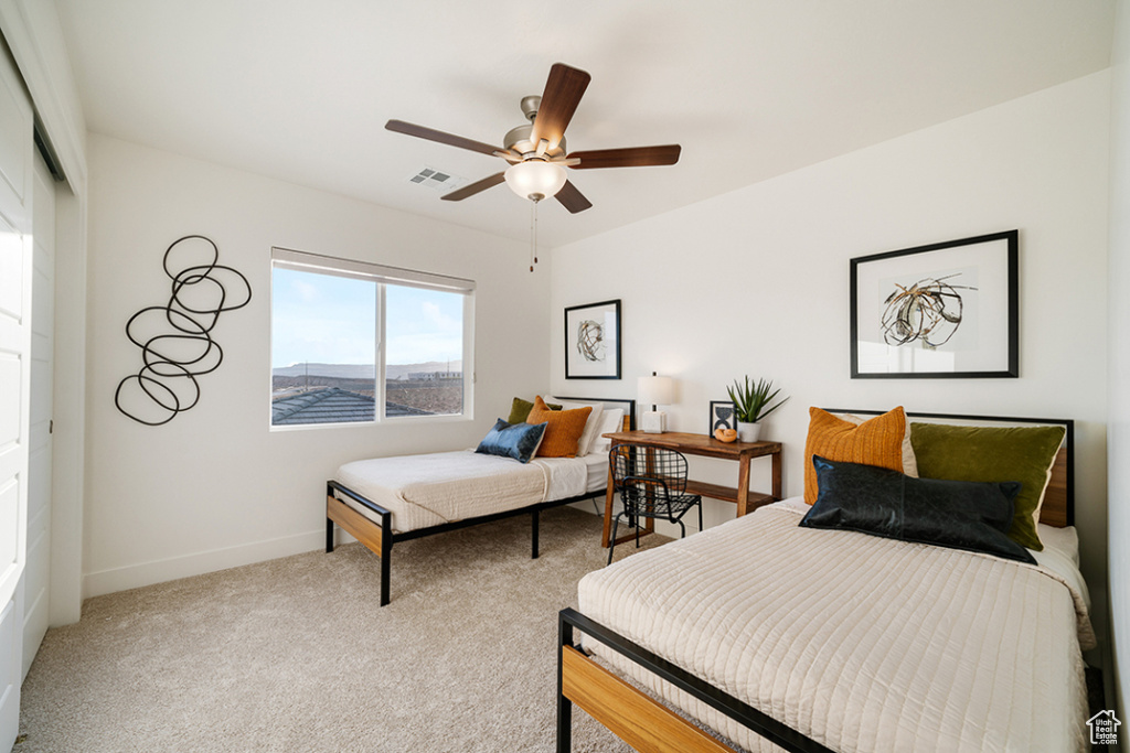Bedroom with carpet floors, a ceiling fan, and a closet