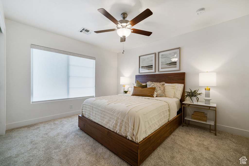 Carpeted bedroom with baseboards and ceiling fan