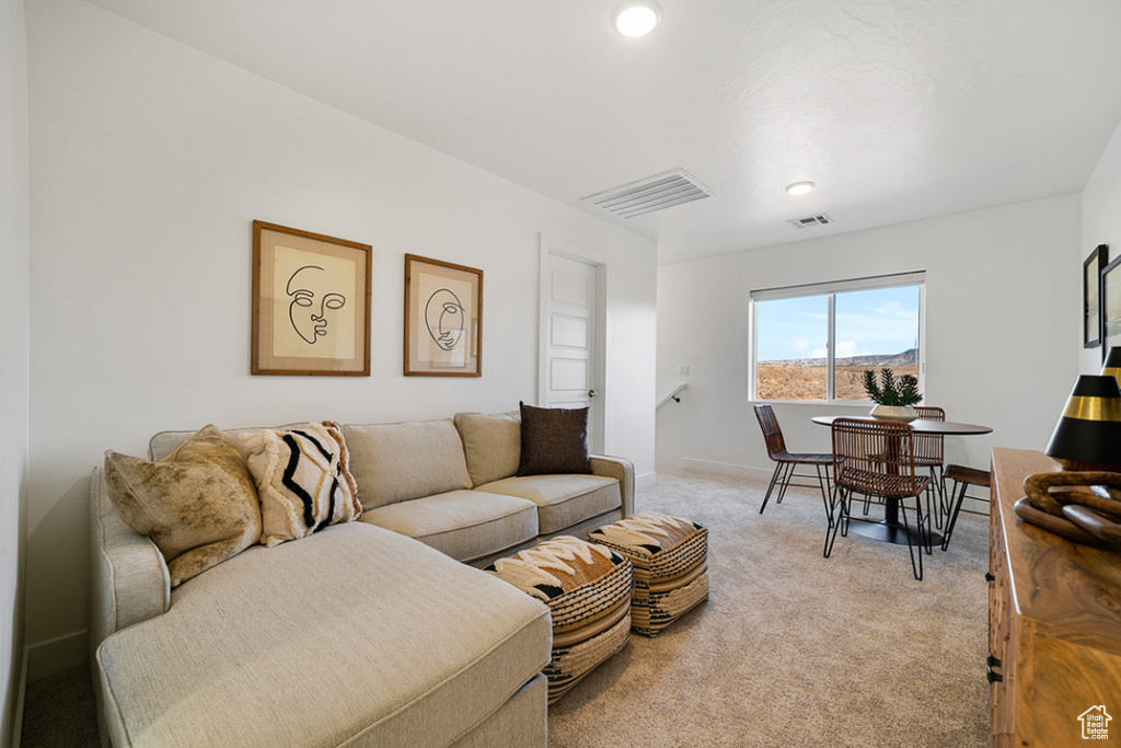 Living room featuring light carpet and recessed lighting