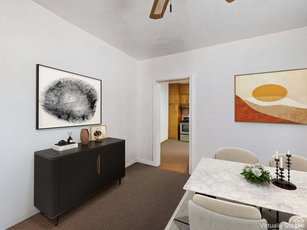 Dining area featuring ceiling fan and carpet floors
