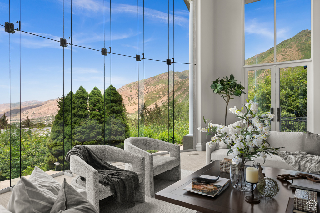 Living room with a mountain view, healthy amount of natural light, and expansive windows