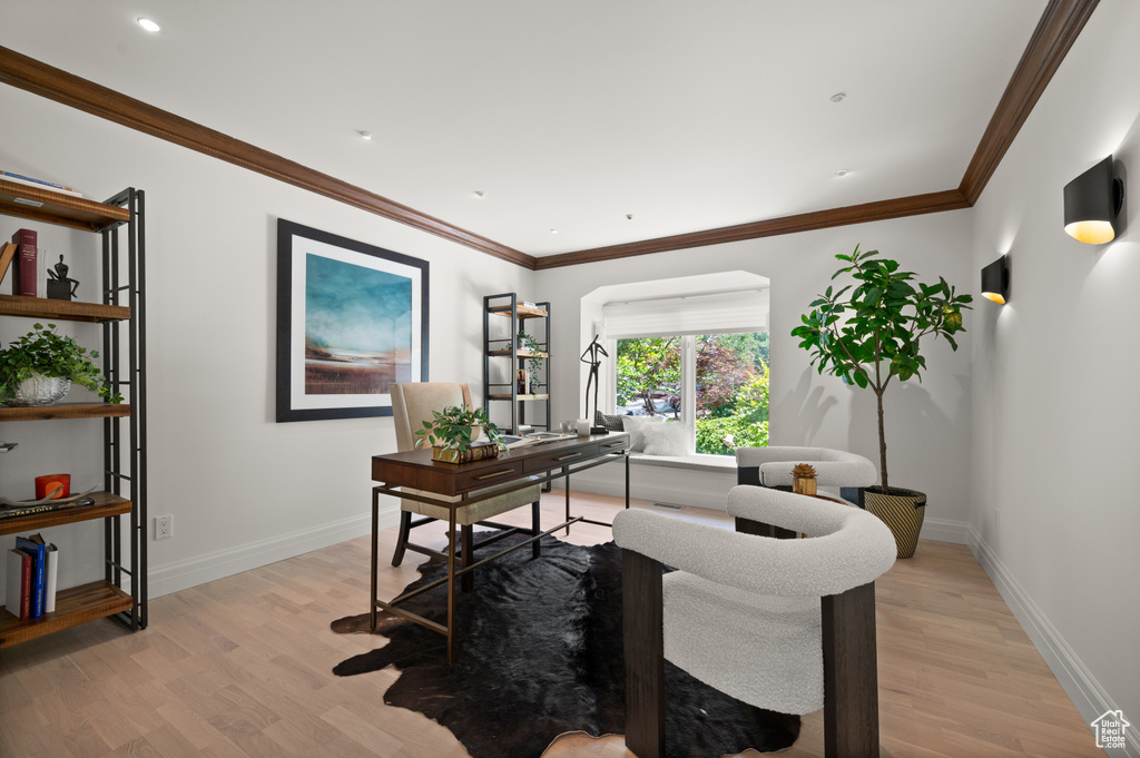 Office featuring light wood-style flooring and ornamental molding