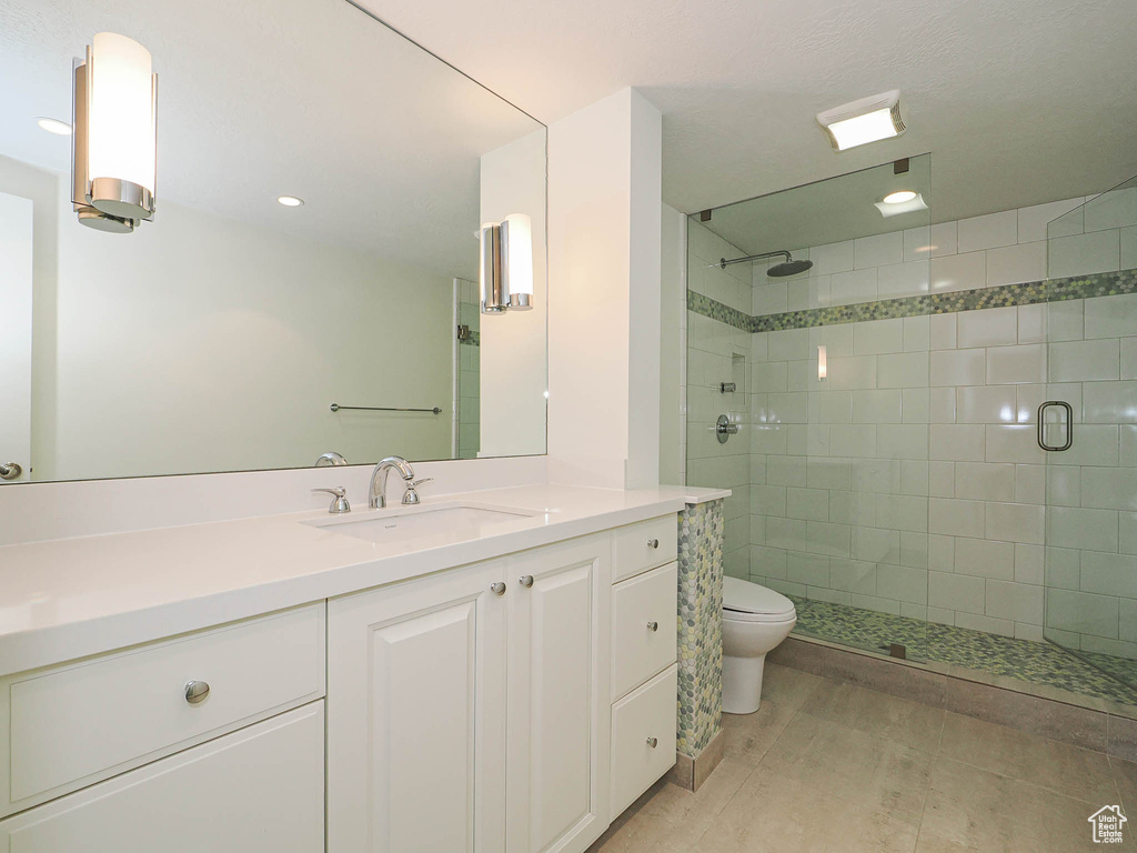 Bathroom featuring vanity, a stall shower, and recessed lighting