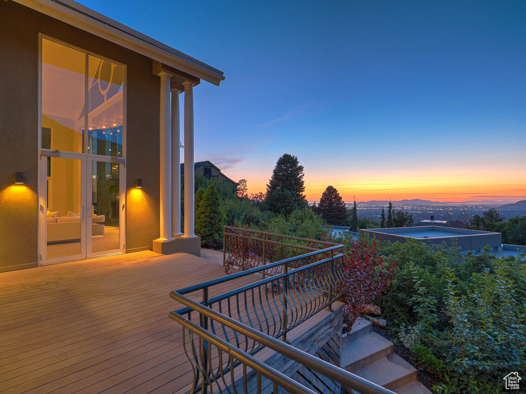 Deck at dusk with a hot tub
