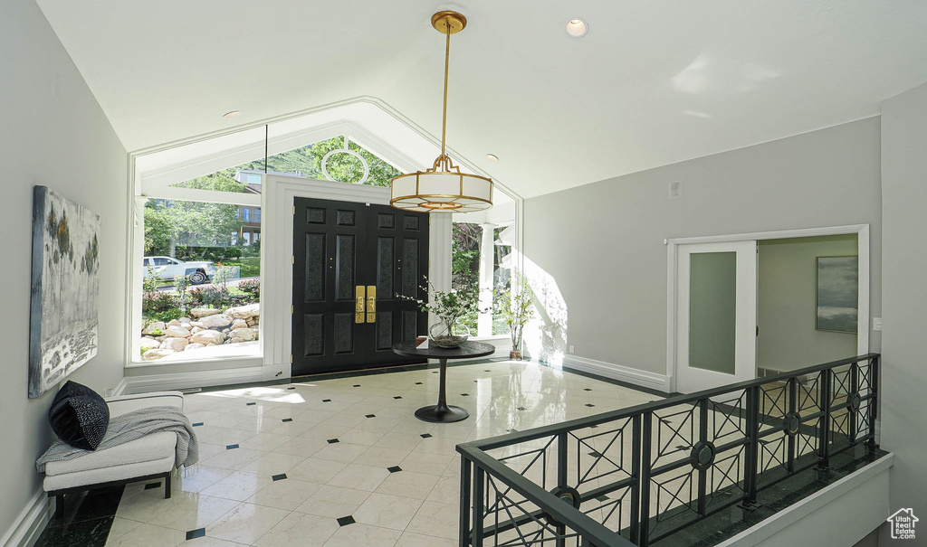 Foyer featuring vaulted ceiling and tile patterned flooring