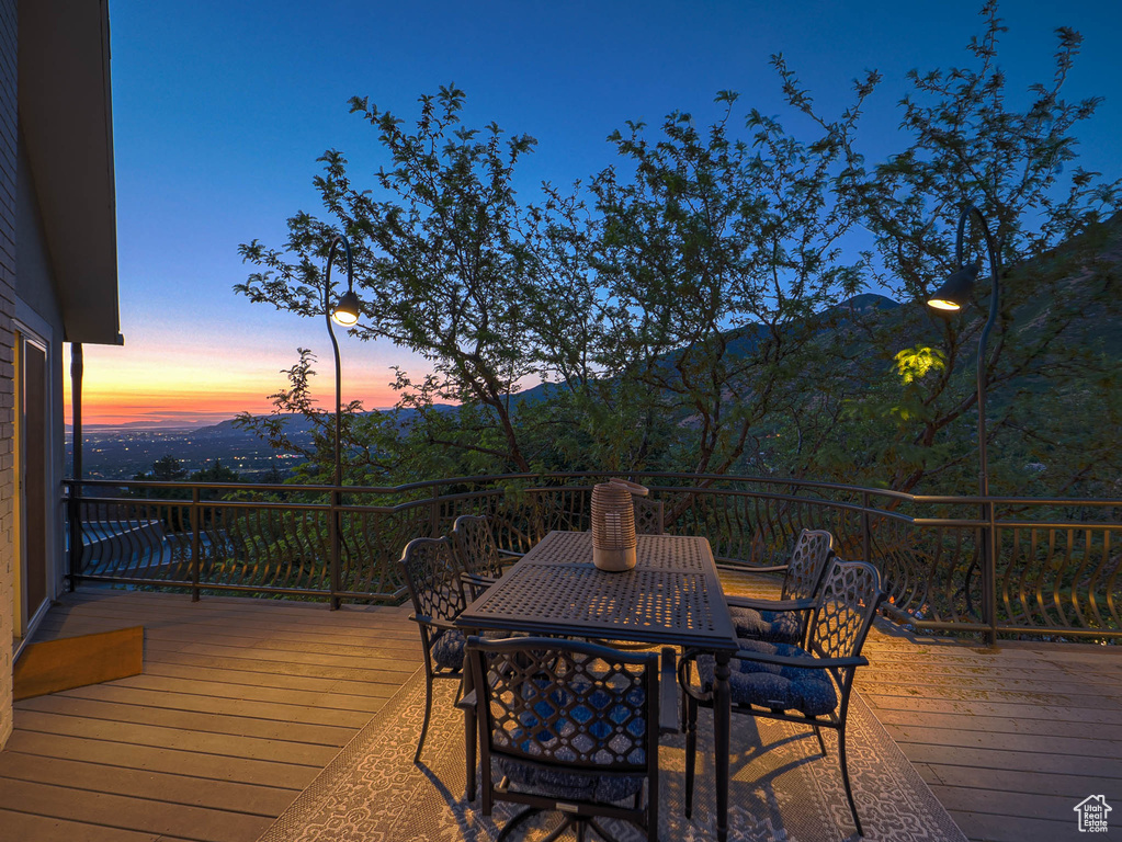 Deck at dusk with outdoor dining space