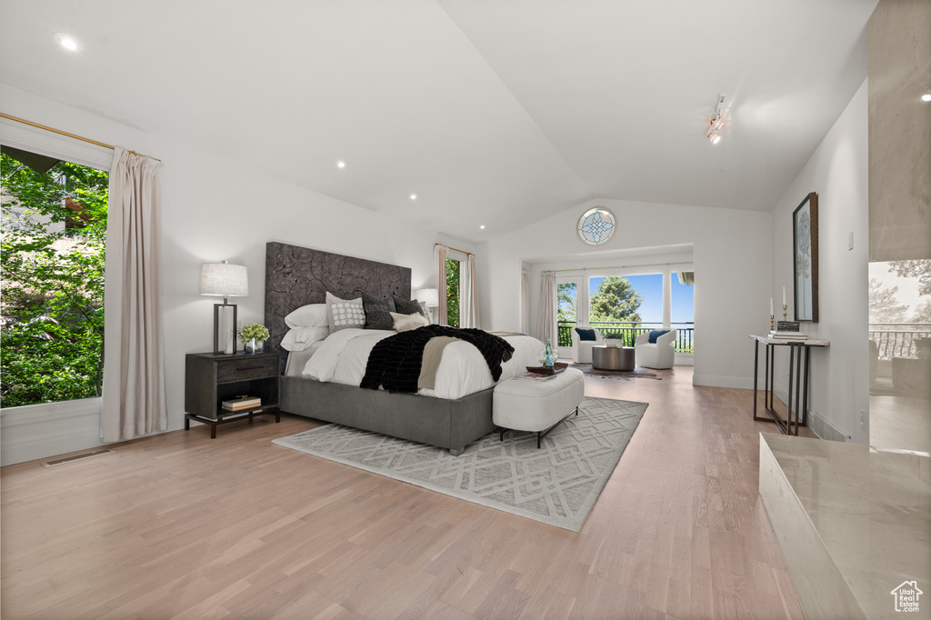 Bedroom with vaulted ceiling and wood finished floors