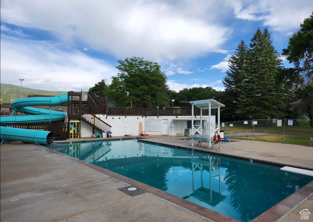 Community pool featuring a water slide