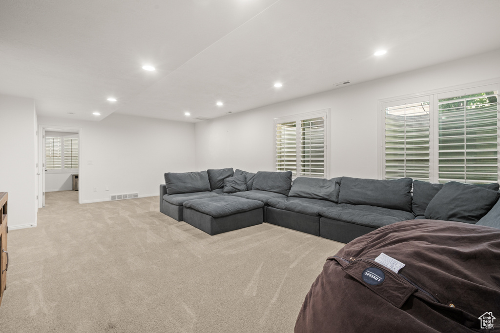 Living room with recessed lighting and light colored carpet