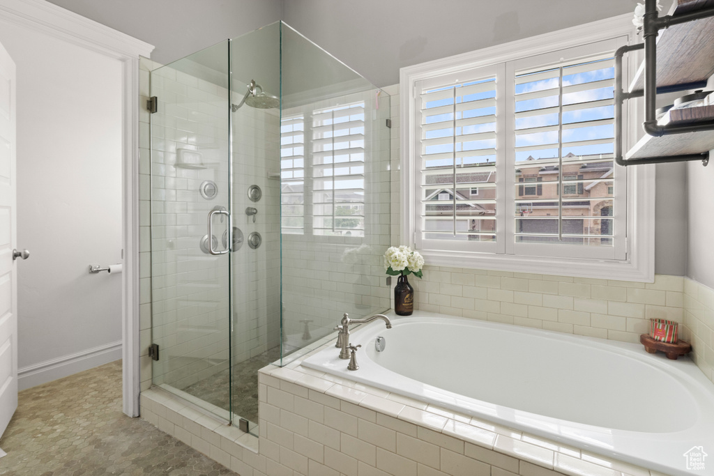 Full bathroom featuring a bath and a shower stall