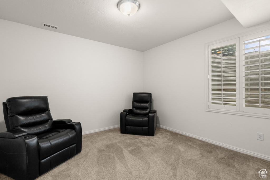 Sitting room featuring carpet and baseboards