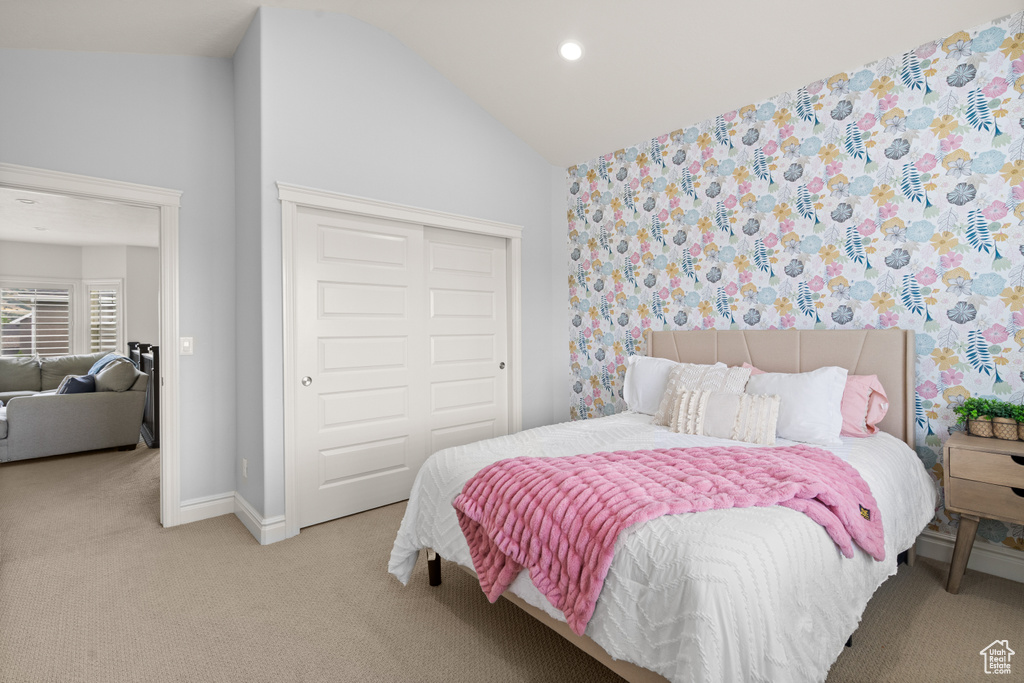 Carpeted bedroom featuring lofted ceiling, a closet, and recessed lighting