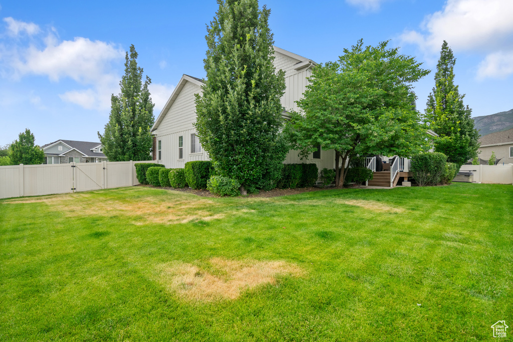 Fenced backyard with a gate and a deck