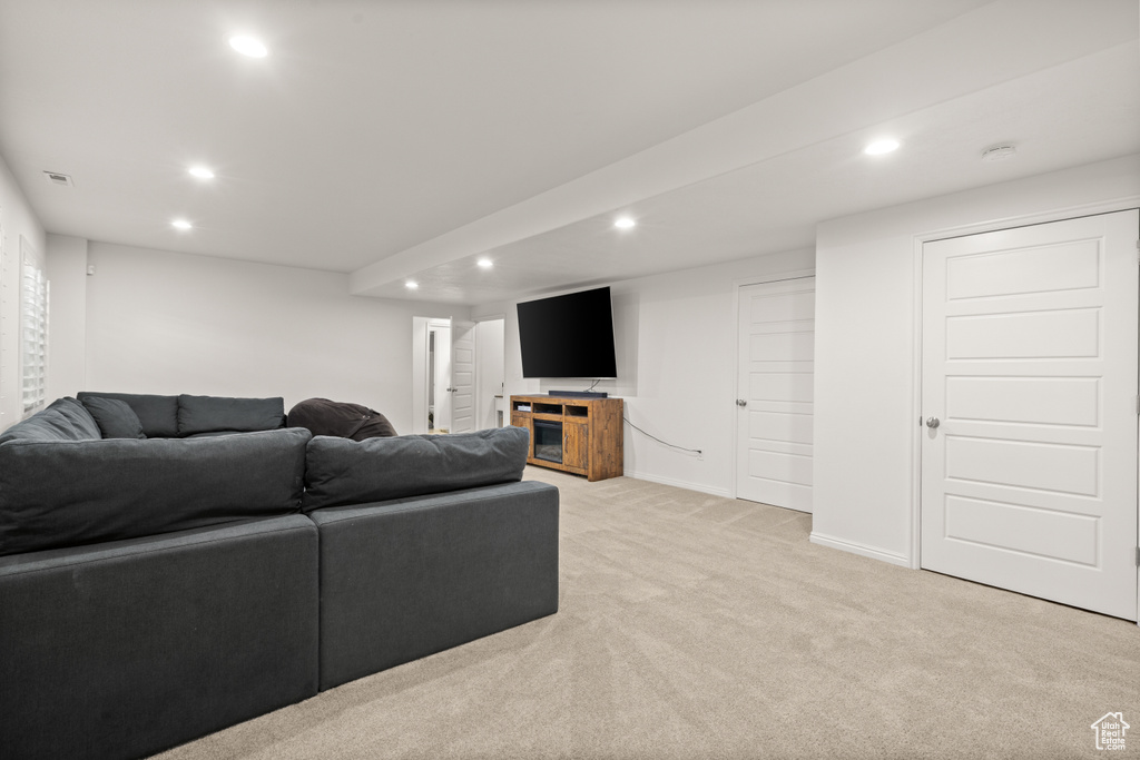 Living area featuring recessed lighting and light colored carpet