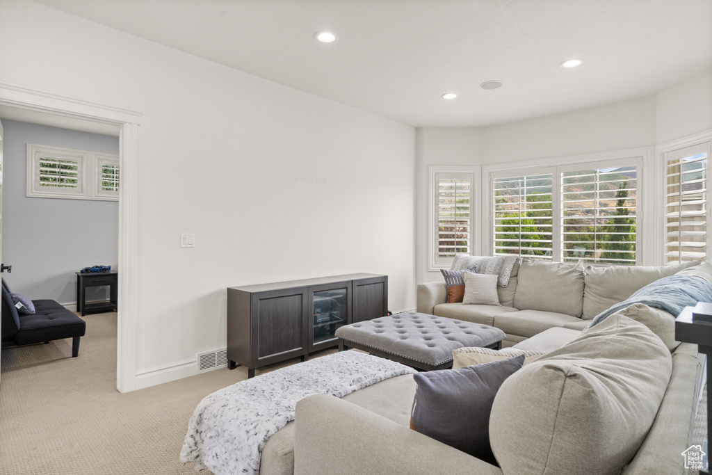 Living room with light carpet and recessed lighting
