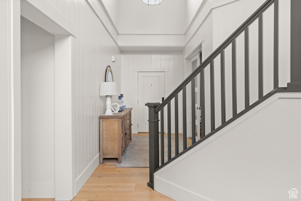 Foyer with light wood-style flooring and stairs